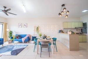 a living room with a table and a blue couch at SetiaWalk {BIG GROUP}12Pax WIFI 2C'Park IOI SUNWAY SUBANG USJ in Puchong