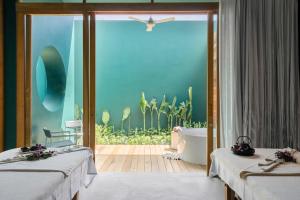 SALA Samui Chaweng Beach Resort客房内的一张或多张床位