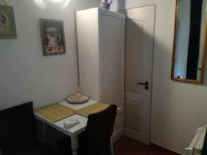 Cette petite chambre comprend une table et une armoire blanche. dans l'établissement Casa Doina, à Băile Felix