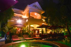 a house with a swimming pool at night at Villa Grange in Phnom Penh