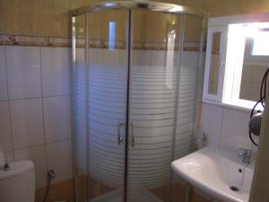 a shower in a bathroom with a toilet and a sink at Villa Pepy in Mesongi +70 photos