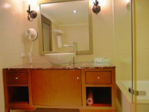 a bathroom with a sink and a mirror and a shower at Kai Wei Boutique Hotel in Taipei