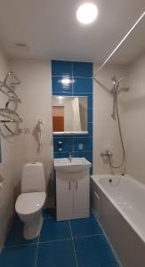 a bathroom with a toilet and a sink and a tub at Sky High Hotel Airport 200 meters from the terminal in Rīga