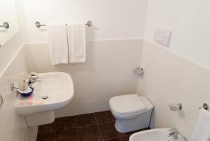 a white bathroom with a toilet and a sink at Bookbreakfast in Terme Vigliatore +18 photos
