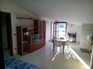 a kitchen with a table and a dining room at Attico Mansardato e Climatizzato con vista Mare in Montesilvano