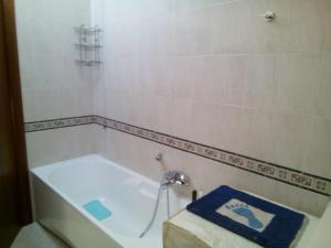 a bath tub with a blue towel sitting on top of it at Attico Mansardato e Climatizzato con vista Mare in Montesilvano