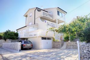 a white house with a car parked in front of it at Villa Luger 1. Stock in Ražanj