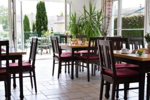 a dining room with tables and chairs in a restaurant at Landhaus Pannonia in Mörbisch am See