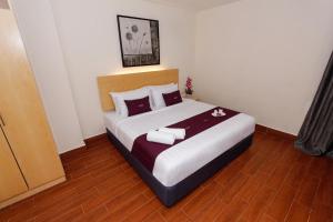 a bedroom with a bed with two towels on it at Metro Hotel @ KL Sentral in Kuala Lumpur