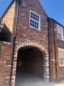 a large brick building with an archway in it at The Lodgings in Beverley
