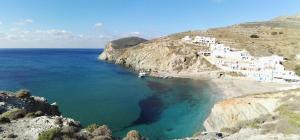 a view of a beach with white buildings and the ocean at Perigiali Rooms & Apartments Folegandros in Agali