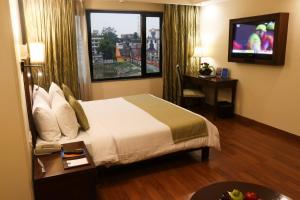 A bed or beds in a room at Le Lac Sarovar Portico- Ranchi