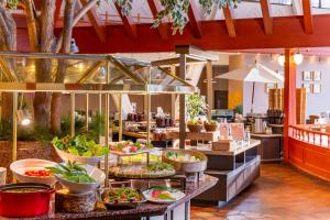 a buffet line with plates of food on display at Kusatsu Onsen Hotel Village in Kusatsu
