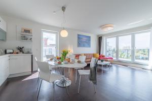 a kitchen and living room with a table and chairs at Villa Bernstein in Börgerende-Rethwisch