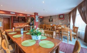 a dining room with a large wooden table and chairs at Family Hotel LILI in Bansko