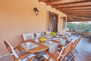 a dining room with a wooden table and chairs at Villa Sansone in Altavilla Milicia