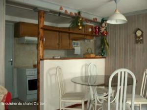a kitchen and dining room with a table and chairs at Ker Cartier in Bolquere Pyrenees 2000