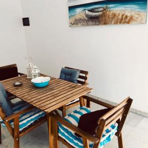a dining room table with chairs and a painting on the wall at Giannakis Filoxenia in Filótion +34 photos