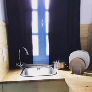 a kitchen counter with a sink and a window at Giannakis Filoxenia in Philotium