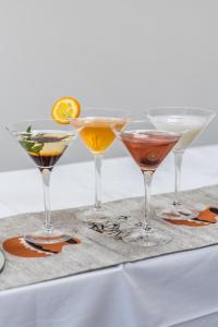 a group of four martini glasses on a table at Glam Hotel Nairobi - Near Westgate Mall, Westlands in Nairobi