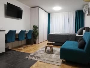 a living room with a couch and a bed at Apartments Ali in Zagreb