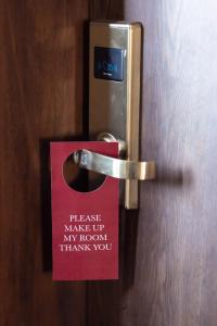 a red sign on a door with a sign on it at Glam Hotel Nairobi - Near Westgate Mall, Westlands in Nairobi