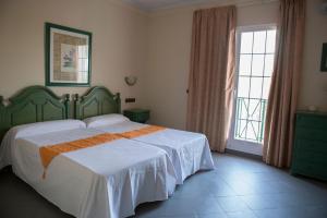 Letto o letti in una camera di Hotel Mitra Crisálida