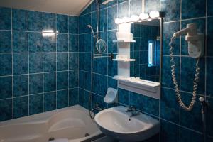 a bathroom with a sink and a bathtub at Hotel Onix in Cluj-Napoca