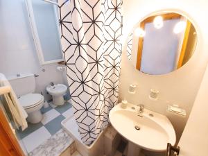 a bathroom with a sink and a mirror and a toilet at Casa con terrazza vista 180° sulla costa orientale in Santa Cesarea Terme