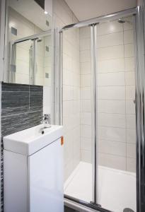 a bathroom with a sink and a shower at Queens Quarter Apartments in Belfast +22 photos