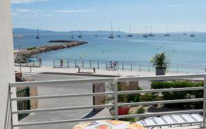 a view of a beach with boats in the water at Les Stoechades in Hyères