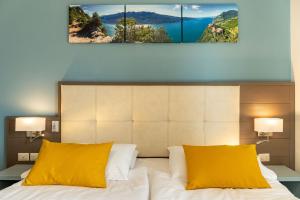 Postel nebo postele na pokoji v ubytování Hotel Limone