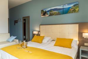 Postel nebo postele na pokoji v ubytování Hotel Limone