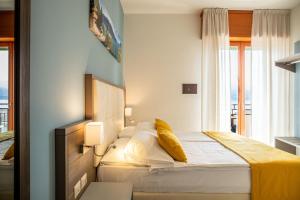Postel nebo postele na pokoji v ubytování Hotel Limone