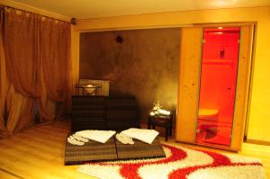 a living room with two beds and a red door at Residence Ranieri in Castiglione del Lago