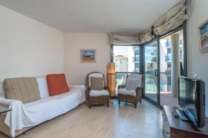 A television and/or entertainment centre at Costabravaforrent Balco 2