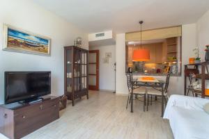 A television and/or entertainment centre at Costabravaforrent Balco 2