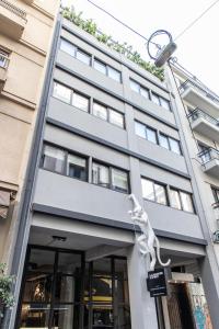 a building with a sculpture on the front of it at 14 Reasons Why Hotel Athens in Athens