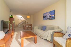 A television and/or entertainment centre at Costabravaforrent Balco 2
