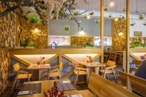 a restaurant with wooden tables and chairs at Central Apartmany in Starý Smokovec