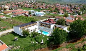 an aerial view of a house with a swimming pool at Hotel Gracanica in Prishtinë