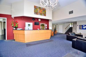 a lobby with a reception desk in a building at Allenby Park Hotel in Auckland