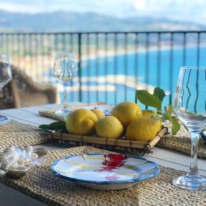 a table with a plate of lemons on it at Borgo Eleatico in Casal Velino