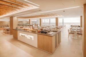 a restaurant with a buffet line with tables and chairs at Benidorm Centre - Adults Only in Benidorm