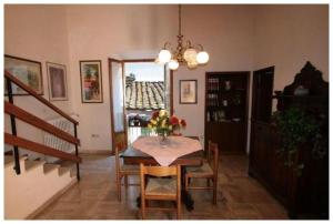 a dining room with a table with a vase of flowers on it at La Torre Useppi in San Gimignano