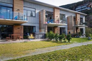 a house with a lawn in front of it at @MyHolidays - My Remarkable view in Queenstown