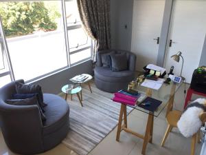 a living room with two chairs and a table at 23 on Camden Guest House in East London