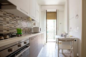 a kitchen with a sink and a stove top oven at Lorenteggio Studio Apt in Milan