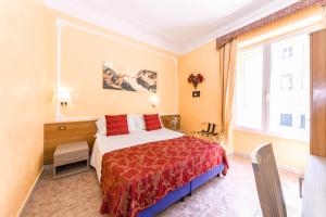 A bed or beds in a room at Downtown Accommodation