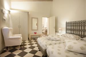 a hotel room with two beds and a chair at Hotel Maison Tresnuraghes in Tresnuraghes +37 photos